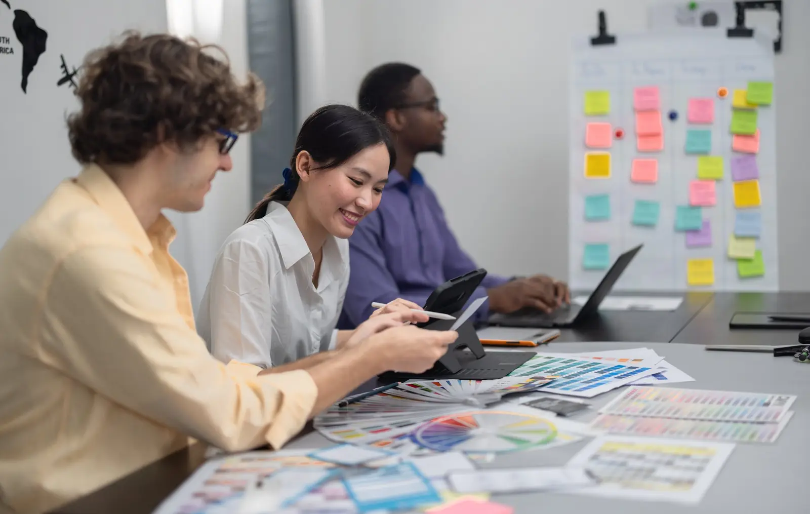 A team reviewing website and app designs together at a desk